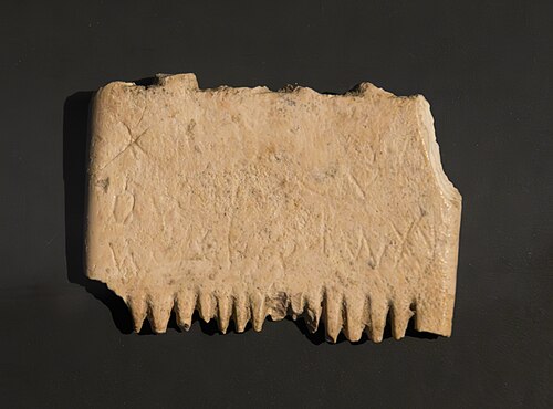 An ivory comb that was discovered in Lachish, and bears a mid to late bronze age inscription that expresses the holder's wish to eradicate lice. The inscription contains the earliest known complete sentence written in a phonetic alphabet, although some reseachers disagree with the reading of the insciption. The picture was taken when the comb was on display in Israel Museum (probably on a temporary display). This image was developed from raw format and denoised.